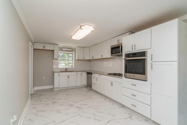 kitchen with tasteful backsplash, white cabinetry, sink, and stainless steel appliances