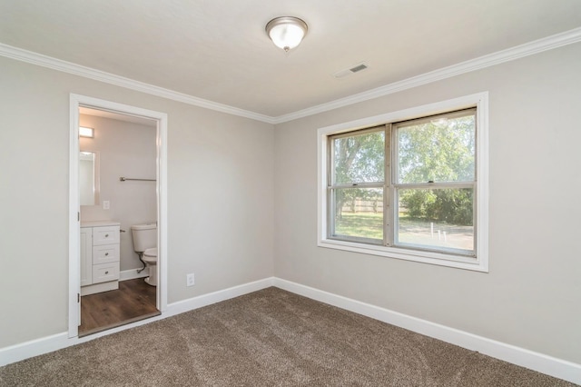 unfurnished bedroom with carpet floors, crown molding, and ensuite bath