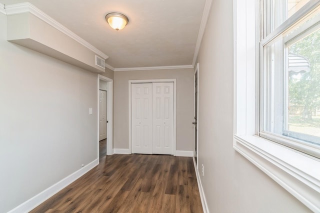 hallway featuring plenty of natural light, crown molding, and dark wood-type flooring