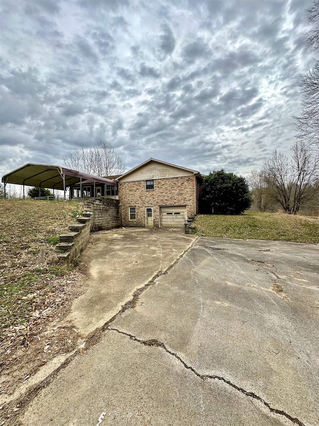 view of side of home with a garage and driveway