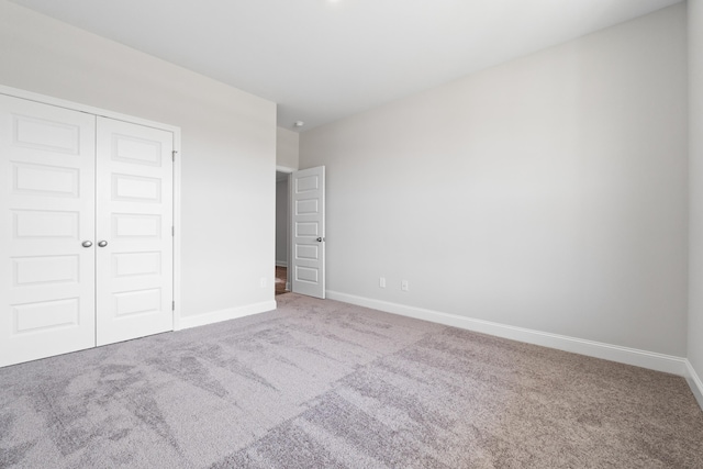 unfurnished bedroom featuring a closet and carpet floors