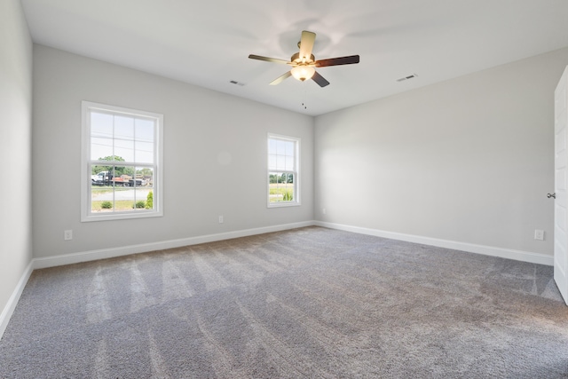 carpeted spare room with ceiling fan