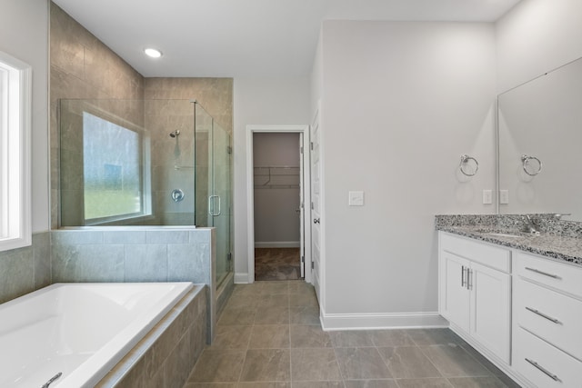 bathroom with tile patterned flooring, shower with separate bathtub, and vanity