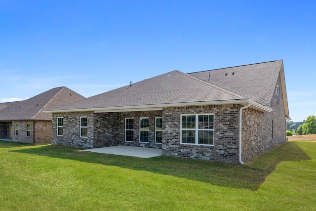 rear view of house with a yard and a patio area