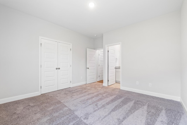 unfurnished bedroom featuring light carpet