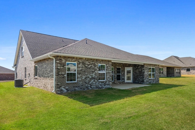 rear view of property with a yard, a patio area, and central air condition unit