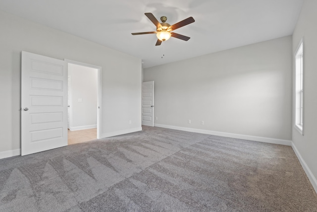 carpeted empty room with ceiling fan