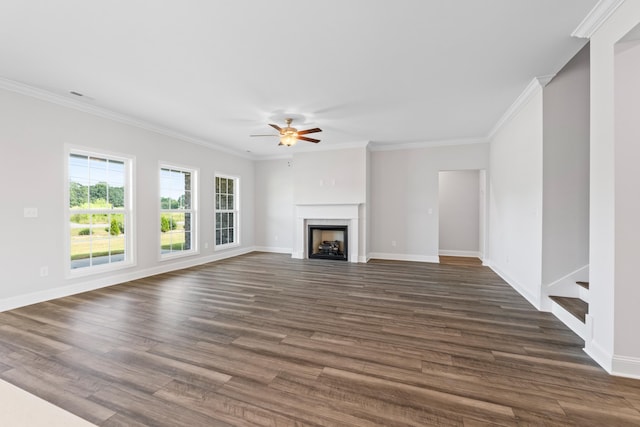 unfurnished living room with crown molding, ceiling fan, and dark hardwood / wood-style floors