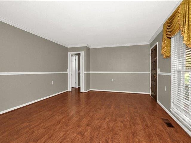 unfurnished room featuring crown molding and dark hardwood / wood-style floors