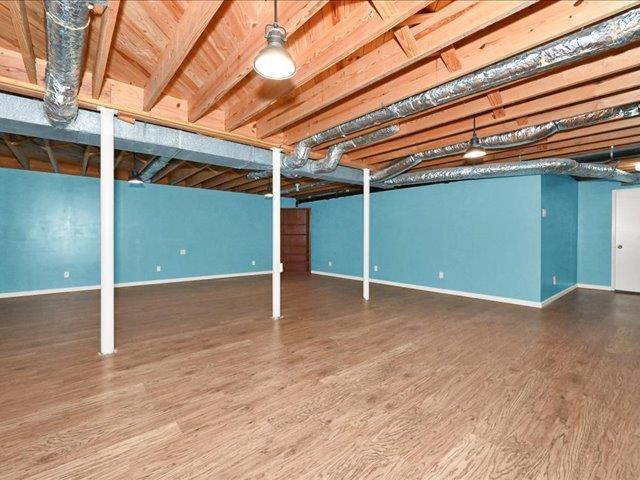 basement with dark hardwood / wood-style flooring