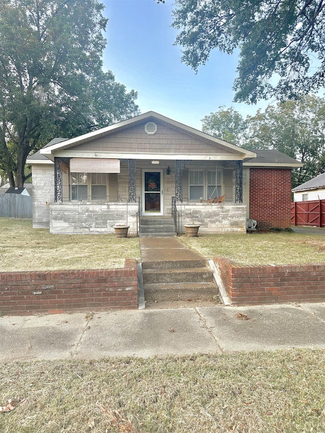 view of front facade with covered porch and a front lawn