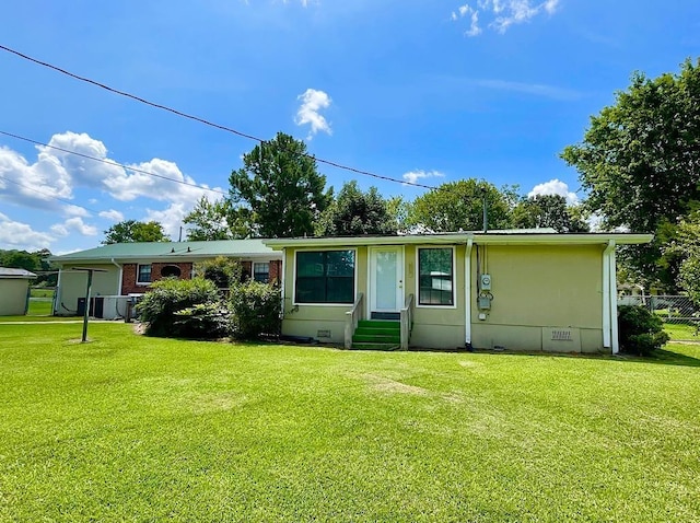 rear view of house featuring crawl space, entry steps, a yard, and fence