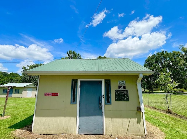 view of outbuilding with an outdoor structure and fence