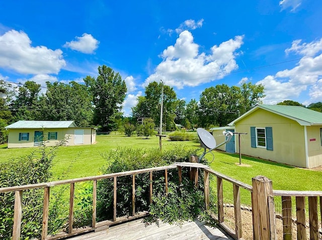 deck with fence, an outdoor structure, and a lawn