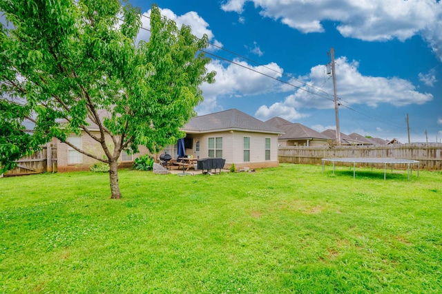  - back of house featuring a trampoline and a patio area