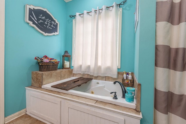  - bathroom featuring a tub with jets