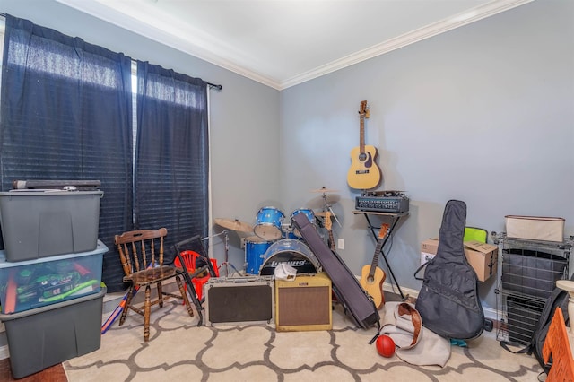  - recreation room featuring crown molding and baseboards