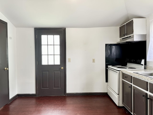 kitchen with dark wood-style flooring, baseboards, and white electric range