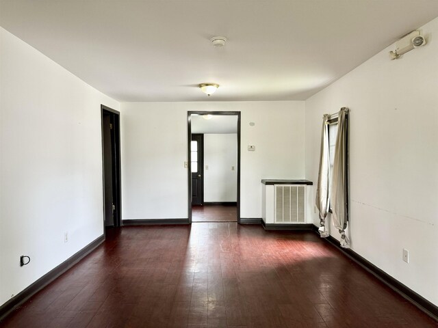  - spare room featuring wood-type flooring, baseboards, and visible vents