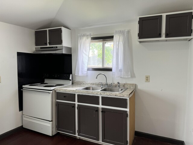  - kitchen featuring lofted ceiling, white electric range, light countertops, under cabinet range hood, and a sink