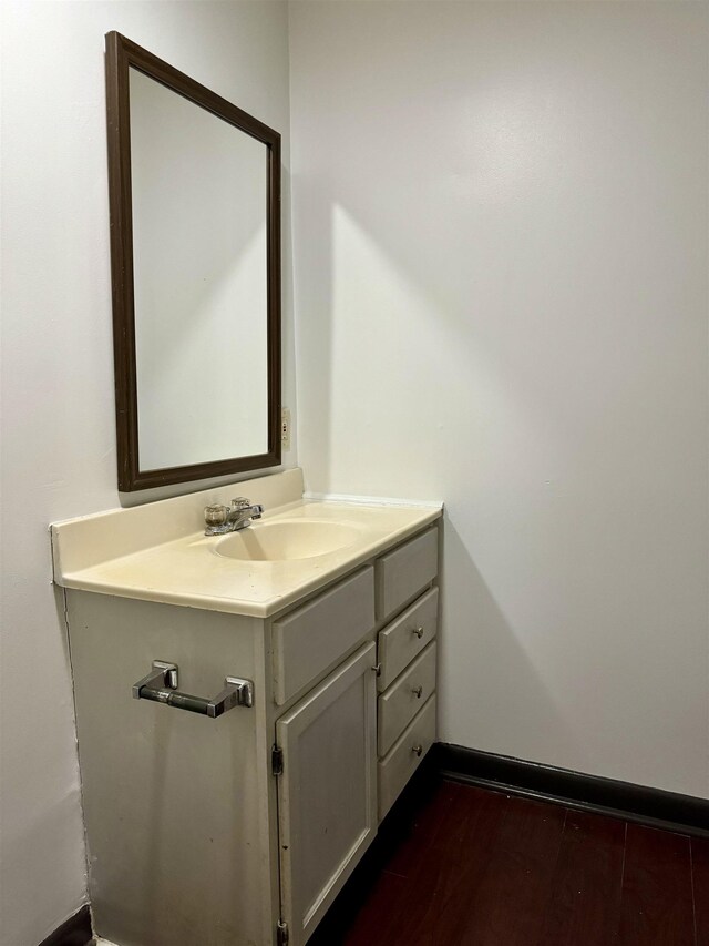  - bathroom featuring wood finished floors and vanity