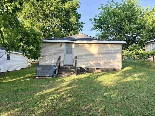  - rear view of property featuring fence, central air condition unit, a yard, and entry steps