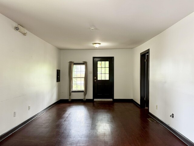 - foyer featuring baseboards, wood finished floors, and visible vents