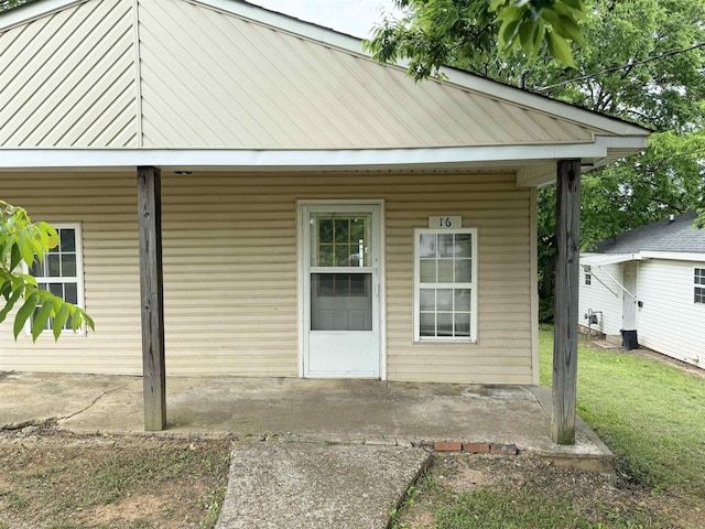 rear view of property with a yard and a patio