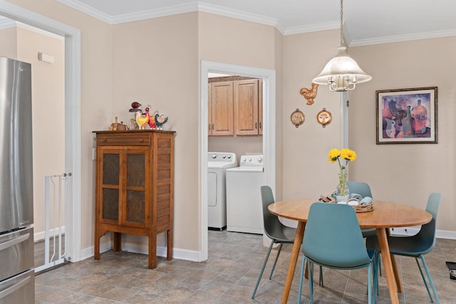 dining area featuring independent washer and dryer, baseboards, crown molding, and stone finish flooring