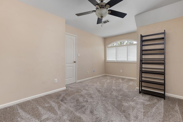 carpeted empty room with ceiling fan and baseboards