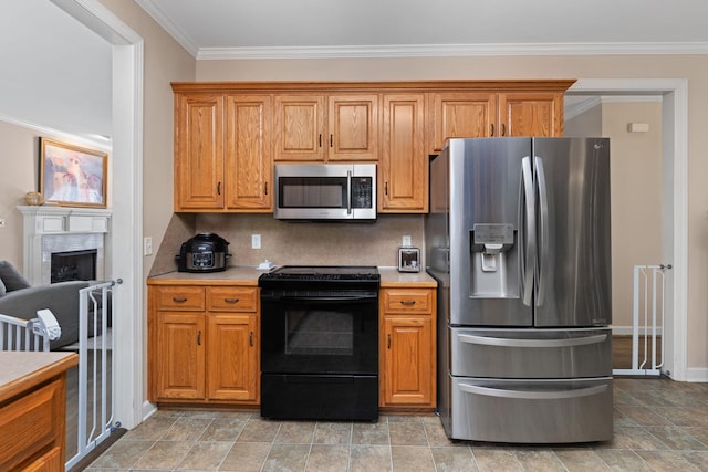 kitchen featuring appliances with stainless steel finishes, light countertops, crown molding, and brown cabinetry