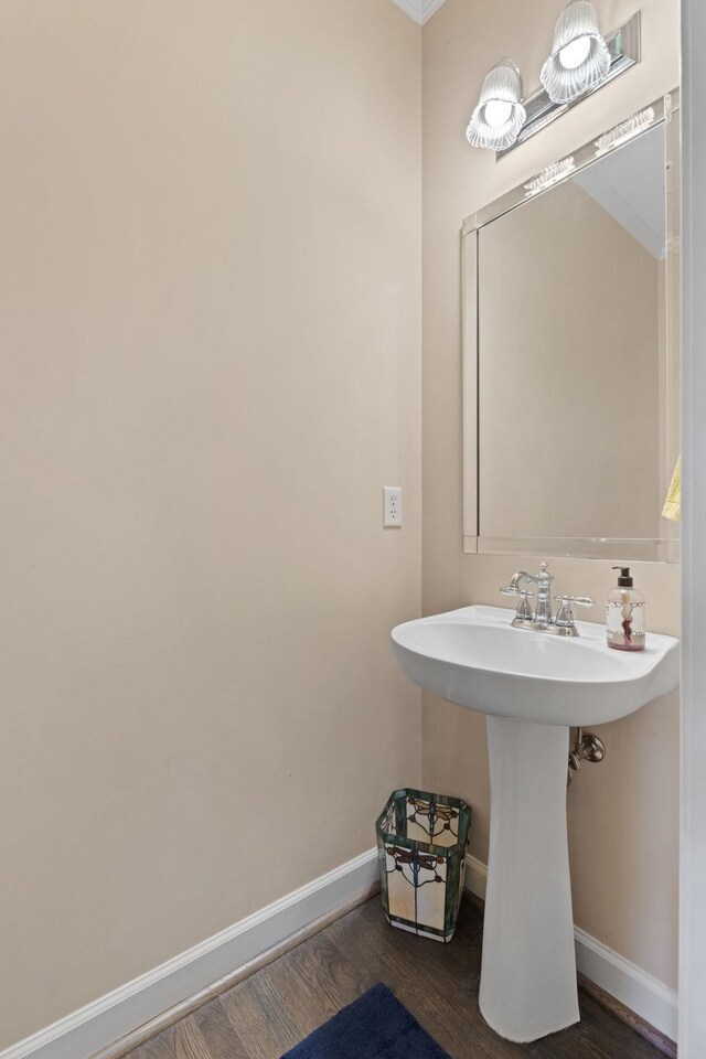 bathroom with wood finished floors and baseboards