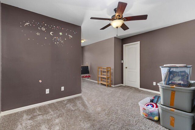 rec room with carpet, a ceiling fan, and baseboards