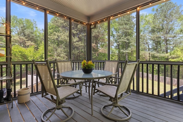 sunroom featuring outdoor dining area