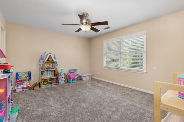 game room with a ceiling fan, carpet, and baseboards