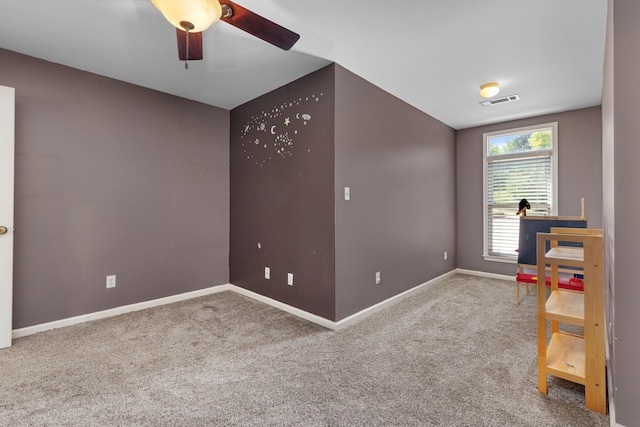 unfurnished room featuring carpet, baseboards, and a ceiling fan