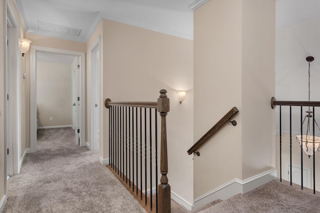 stairs featuring carpet floors, crown molding, and baseboards