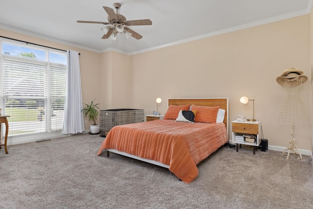 carpeted bedroom featuring ornamental molding, baseboards, and a ceiling fan
