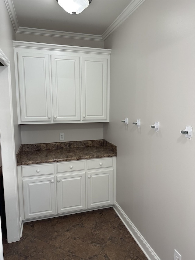  - washroom with crown molding and dark stone finish flooring