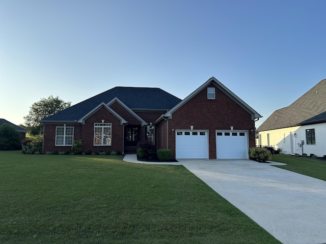  - view of front facade featuring a front yard, driveway, brick siding, and an attached garage