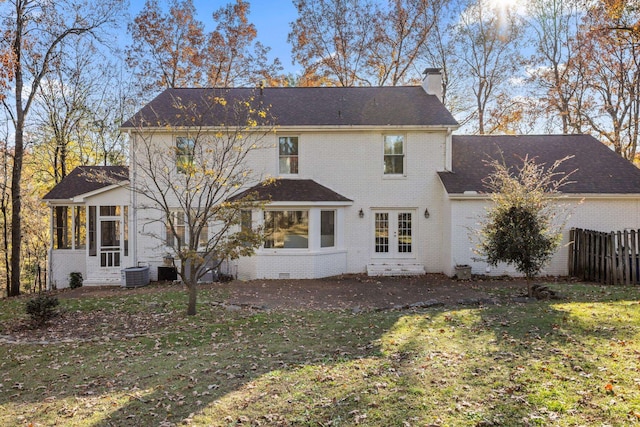 back of property featuring central AC unit, a lawn, and french doors