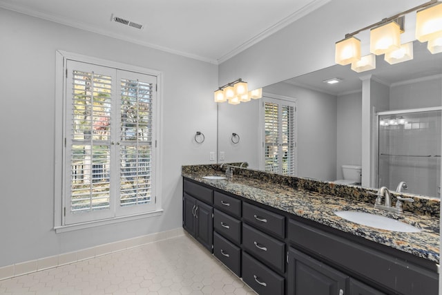 bathroom with a shower with door, vanity, ornamental molding, tile patterned floors, and toilet