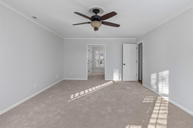 carpeted empty room featuring crown molding and ceiling fan