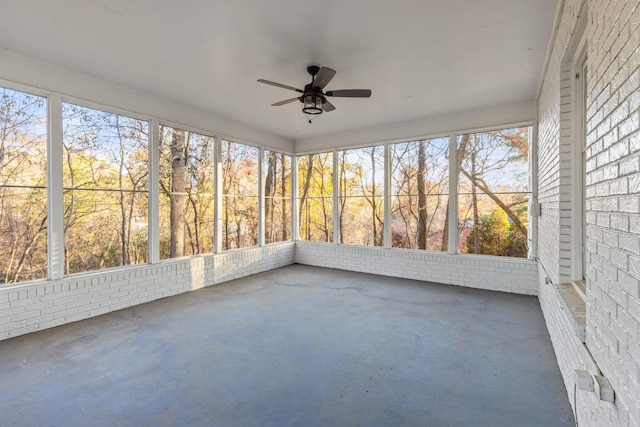 unfurnished sunroom featuring ceiling fan