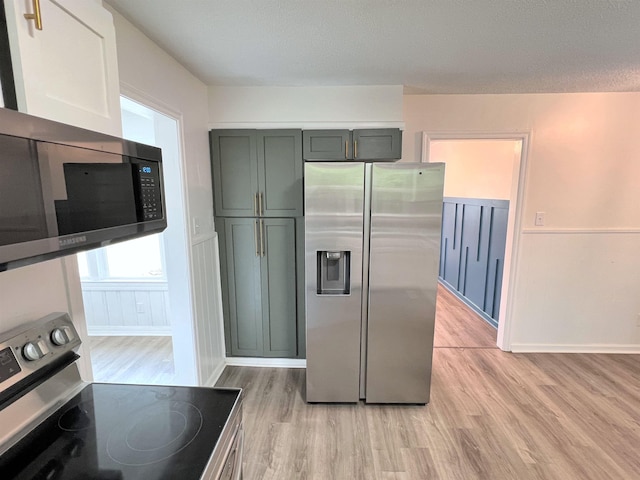  - kitchen featuring stainless steel appliances and light wood-style flooring