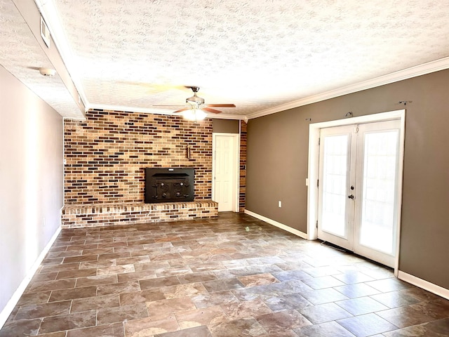 unfurnished living room featuring crown molding, a wood stove, a textured ceiling, and french doors