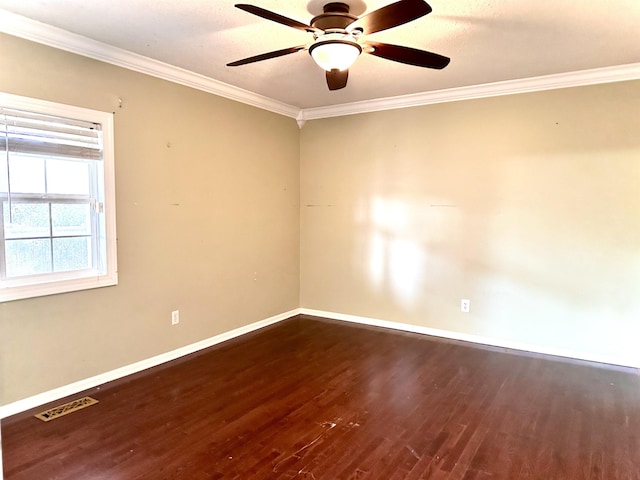 empty room featuring dark hardwood / wood-style flooring, crown molding, and ceiling fan