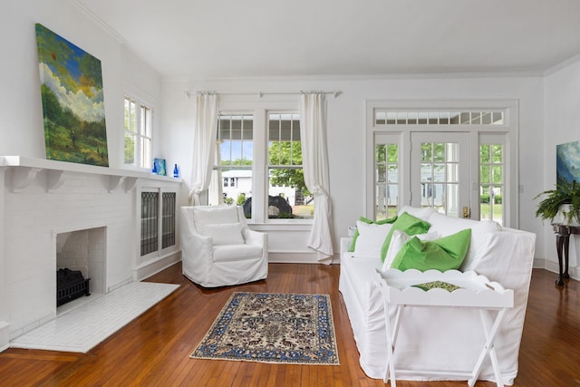  - living area featuring crown molding, wood finished floors, and a fireplace