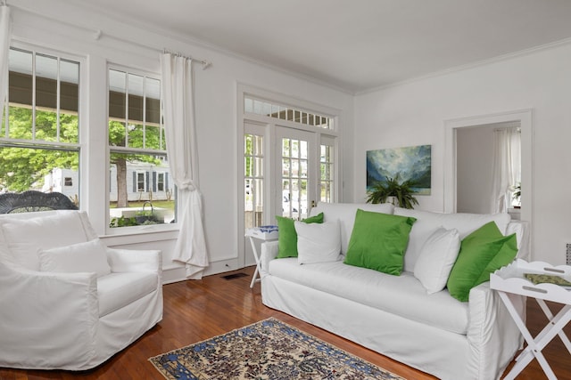  - living area with crown molding, wood finished floors, and visible vents