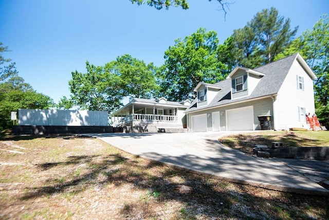 back of property featuring a yard and a garage